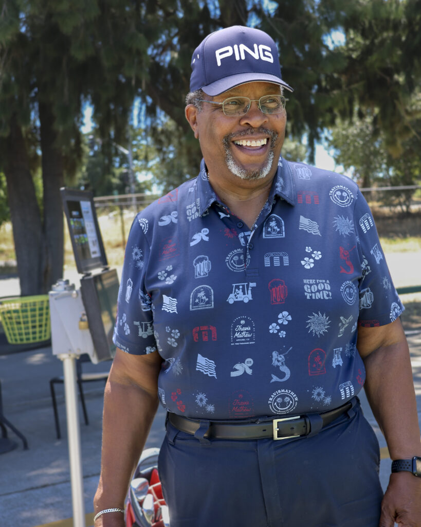 Smiling Man in Travis Mathew Polo at the Driving Range