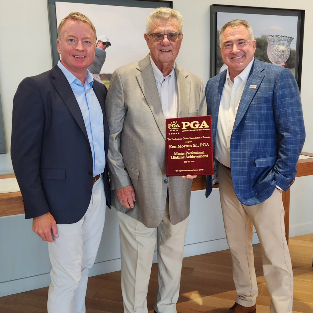 Ken Morton Sr holding up PGA Lifetime Acheivement Award Plaque