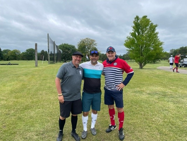 three footgolf players on golf course after round