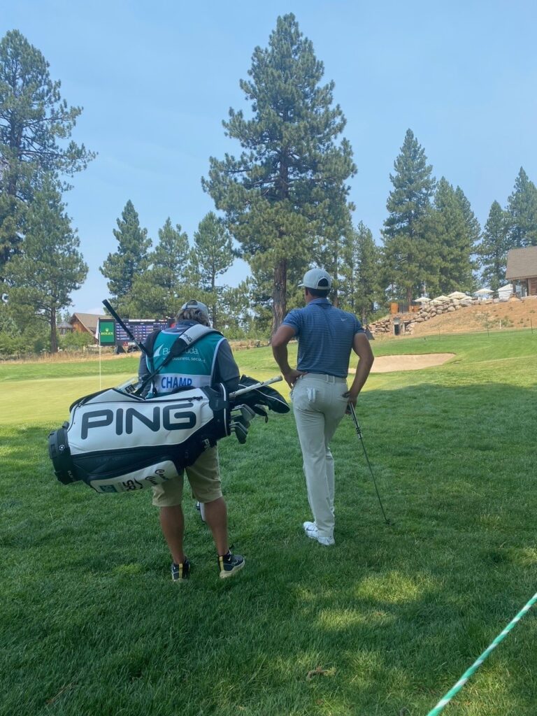 Cameron Champ and his caddy look onto a green at the Barracuda Championship.