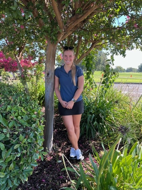 Soliel Gutchess in front of tree at Haggin Oaks Golf Course