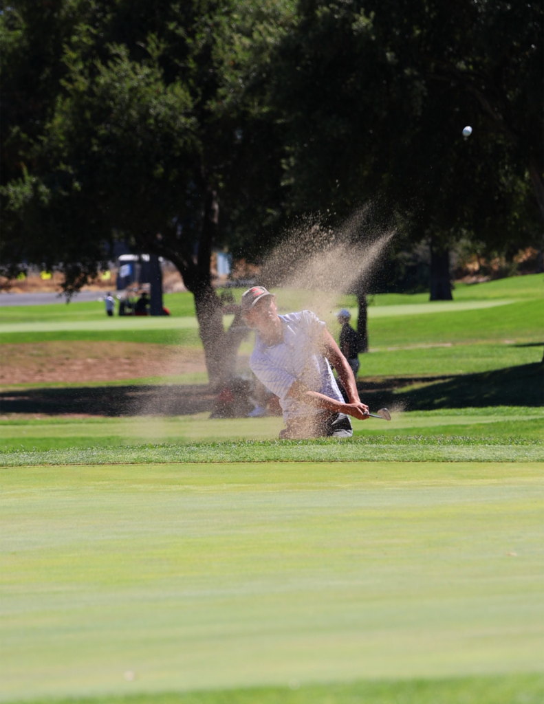 California State Fair Golf Championship golfer hitting the ball out of a sand bunker