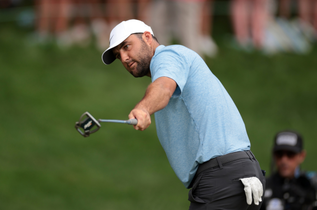 Scottie Sheffler raises putter