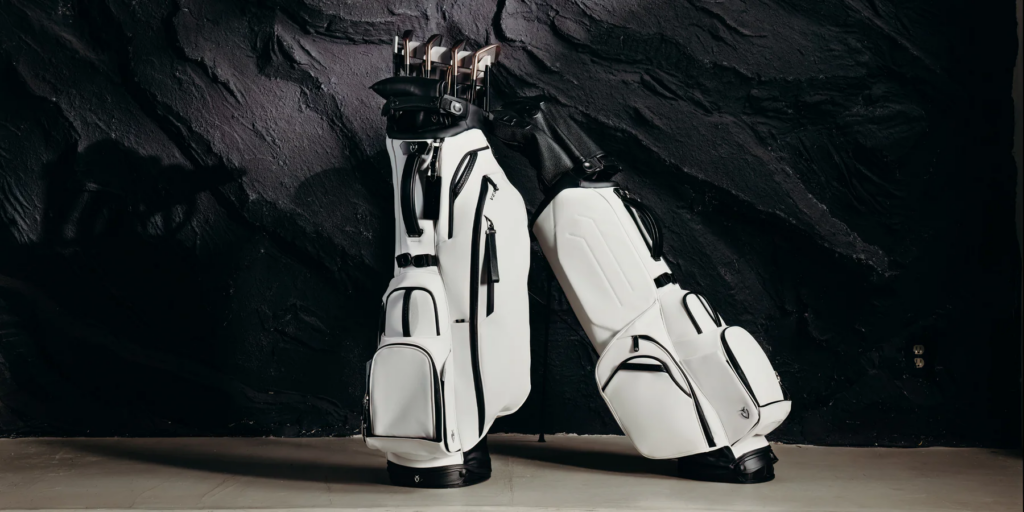 Two White and Black Golf Bags leaning on each other