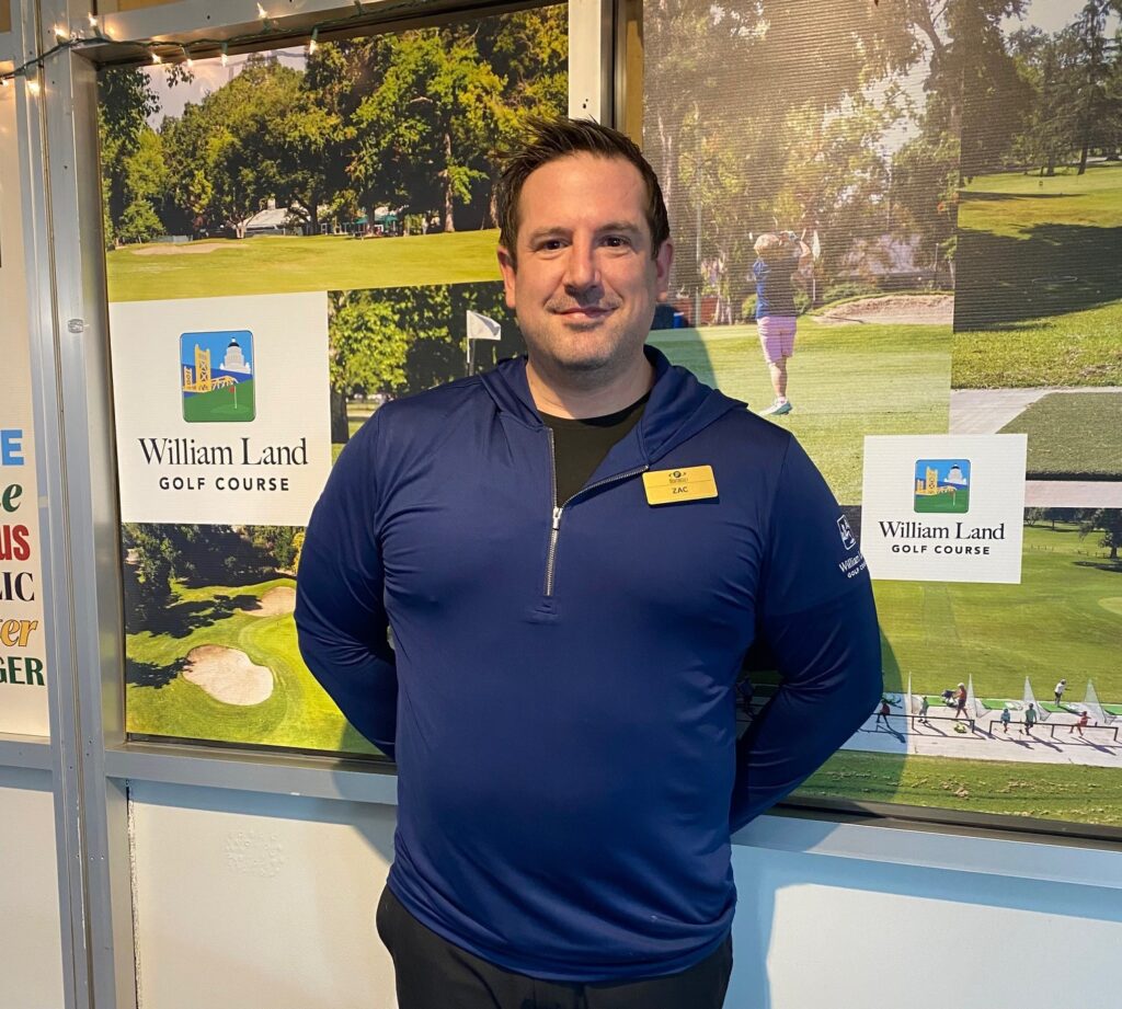 Man standing in front of golf course