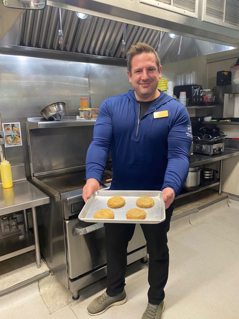 Man holding muffins he bakes